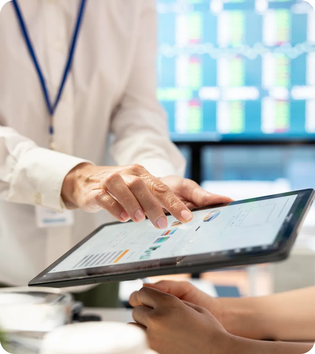 A clinician reviewing records on a tablet with a colleague